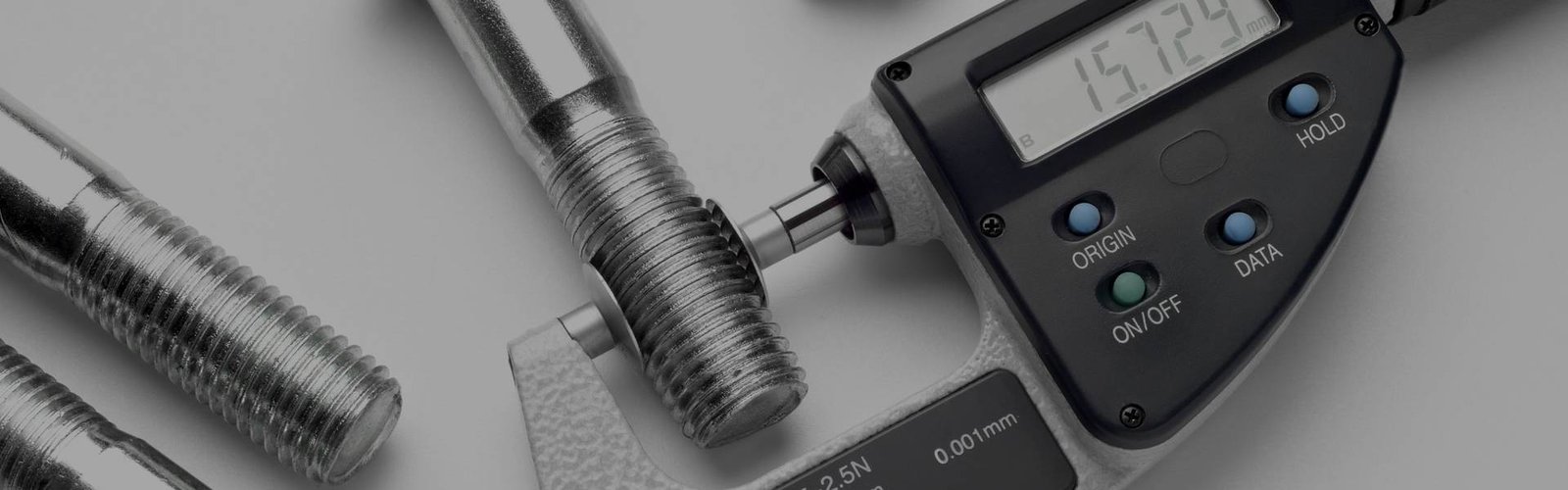 Micrometer and threaded tap used for checking machined threads